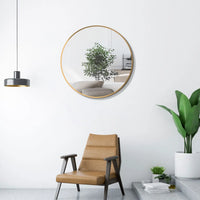 Decor wall mirror round with matt gold frame, without lighting.